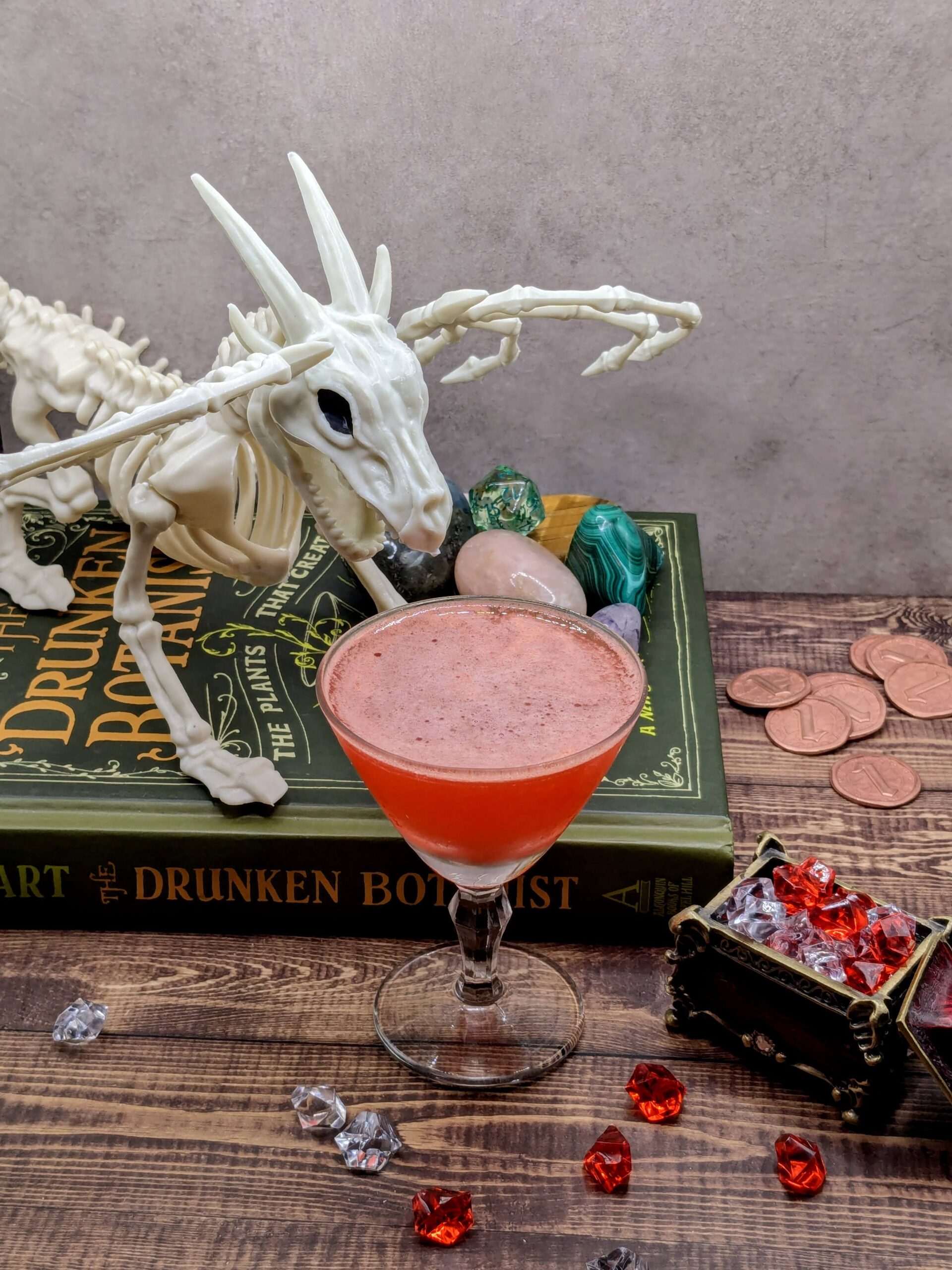 A dungeons and dragon (DND) themed photo with a dragon skeleton, gems and a potion of corpse revival