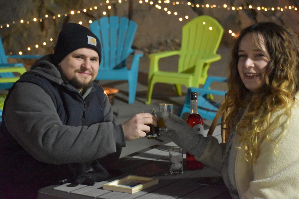 Couple enjoying cocktail flights at Controlled Entropy Distilling