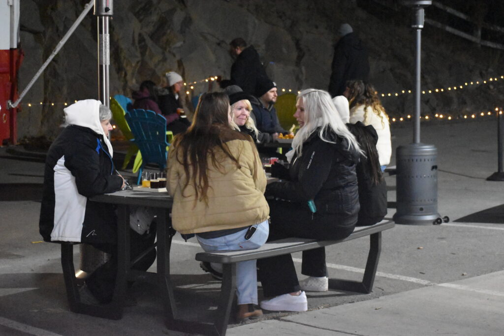 A group of people enjoying drinks on Controlled Entropy's patio